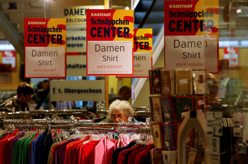 © Reuters. FILE PHOTO - Shoppers look for goods in a Karstadt hot deal department store in  in Frankfurt/Oder