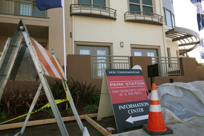 © Reuters. Construction equipment sits next to signs advertising new condominium homes for sale in South San Francisco