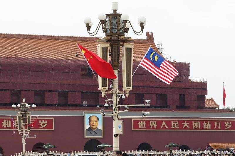 © Reuters. Malaysian flag flutters next to a Chinese flag as Malaysian Prime Minister Mahathir Mohamad visits China, at Tiananmen Square in Beijing