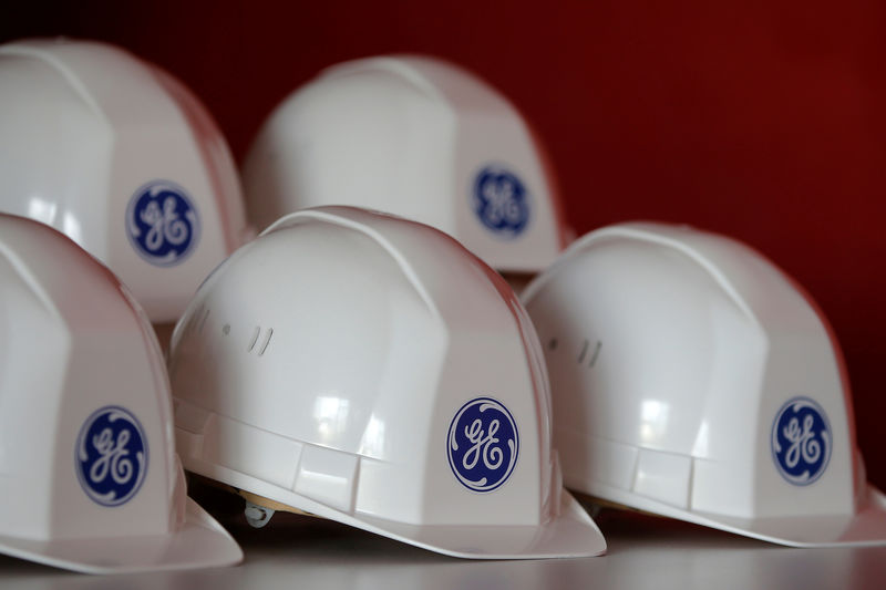 © Reuters. FILE PHOTO: The General Electric logo is pictured on working helmets during a visit at the General Electric offshore wind turbine plant in Montoir-de-Bretagne