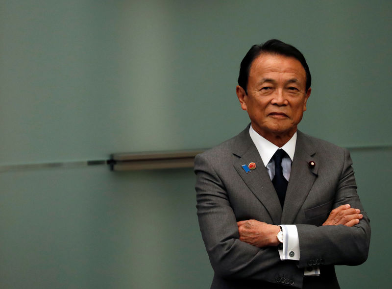 © Reuters. Japanese Deputy Prime Minister and Finance Minister Taro Aso looks on during Prime Minister Shinzo Abe and U.S. Vice President Mike Pence's joint news announcement in Tokyo, Japan