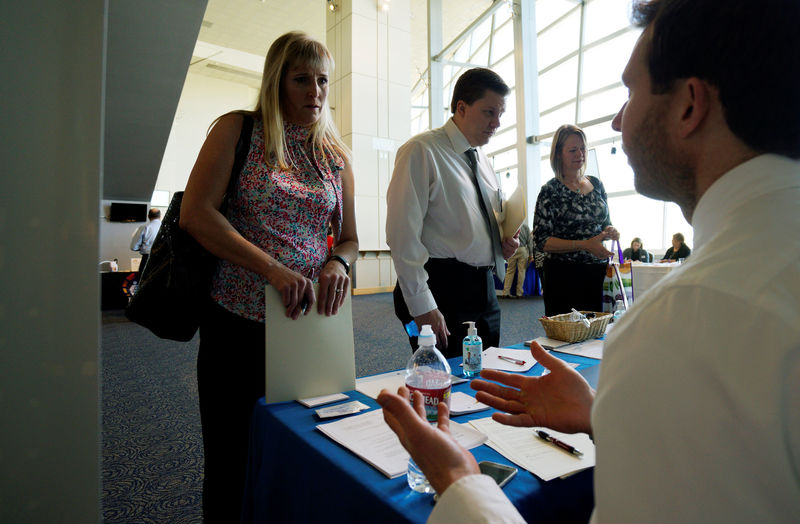 © Reuters. A job seeker listens to a recruiter at a health care job fair sponsored by the Colorado Hospital Association in Denver