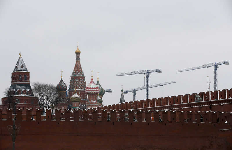 © Reuters. Construction cranes are seen behind the St. Basil's Cathedral and the Kremlin walls in the capital Moscow