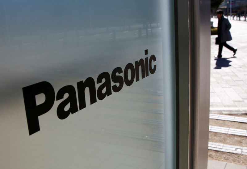 © Reuters. FILE PHOTO - A man is seen next to Panasonic Corp's logo at Panasonic Center in Tokyo