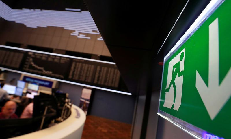 © Reuters. An emergency exit sign is seen next to the German share prize index DAX board on the day of the Brexit vote of the British parliament in Frankfurt