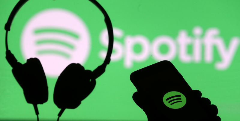 © Reuters. A smartphone and a headset are seen in front of a screen projection of Spotify logo, in this picture illustration