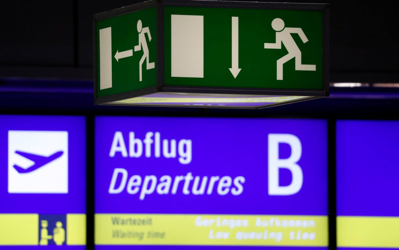 © Reuters. FILE PHOTO: An emergency exit sign is seen outside a security screening area at Germany's largest airport, Fraport, in Frankfurt