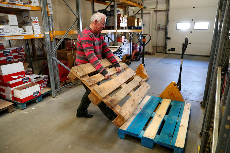 © Reuters. 66-year-old pensioner, Ince moves a pallet in a warehouse in Budapest