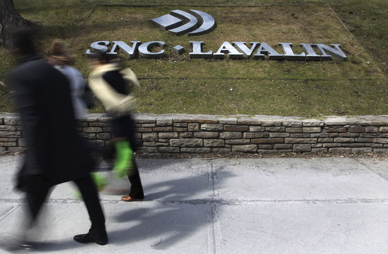 © Reuters. Pedestrians walk past a sign for the head office of SNC Lavalin in downtown Montreal