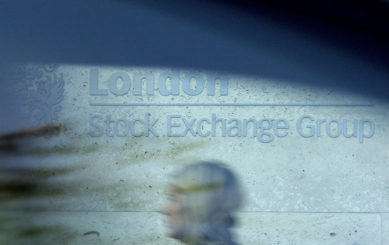 © Reuters. FILE PHOTO:  A woman is seen through a car window as she walks past the London Stock Exchange