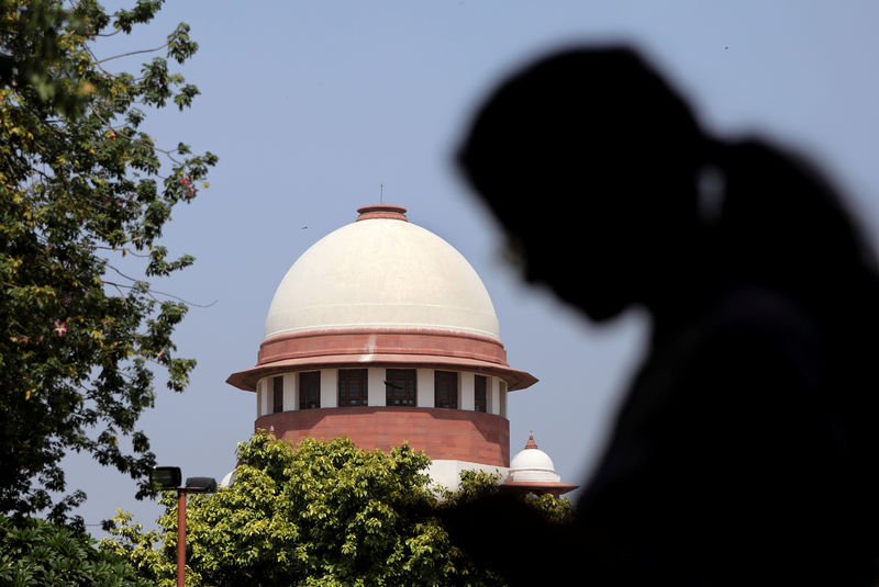 © Reuters. A woman checks her mobile phone inside the premises of the Supreme Court in New Delhi