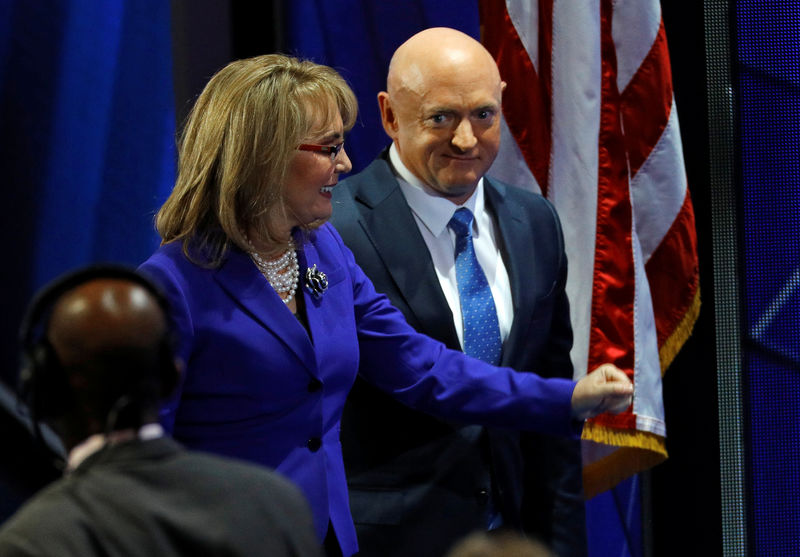 © Reuters. FILE PHOTO: Former U.S. Representative Gabby Giffords (D-AZ) and her husband Mark Kelly walk off the stage after addressing the Democratic National Convention in Philadelphia