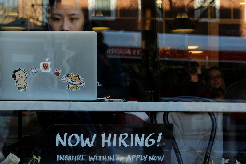 © Reuters. FILE PHOTO: A "Now Hiring" sign sits in the window of Tatte Bakery and Cafe in Cambridge