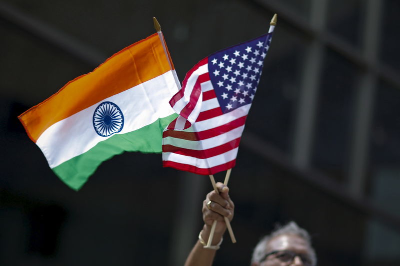 © Reuters. Man holds the flags while people take part in the 35th India Day Parade in New York