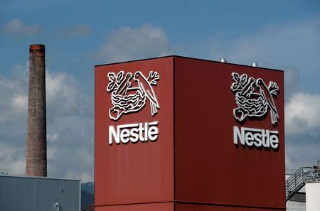 © Reuters. FILE PHOTO: A Nestle logo is pictured on a coffee factory in Orbe