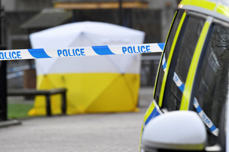 © Reuters. FILE PHOTO: A police car is parked next to crime scene tape, as a tent covers a park bench on which former Russian inteligence officer Sergei Skripal, and a woman were found unconscious after they had been exposed to an unknown substance, in Salisbury