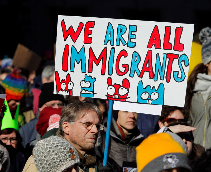 © Reuters. A demonstrator holds a sign to protest against Trump's executive order banning refugees and immigrants from seven primarily Muslim countries from entering the United States during a rally in Philadelphia.