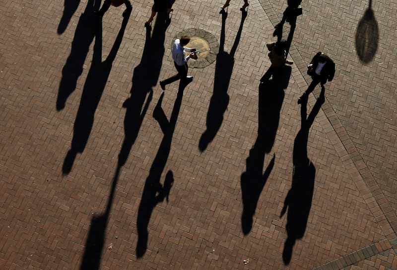 © Reuters. Commuters cast their shadows as they arrive at the Central Business District during the morning rush hour in Sydney