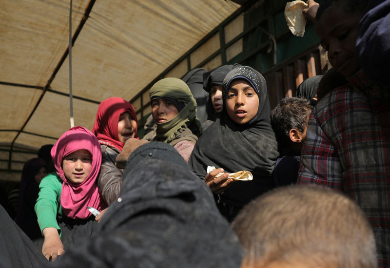 © Reuters. Crianças na parte de trás de caminhão perto de Baghouz, na Síria