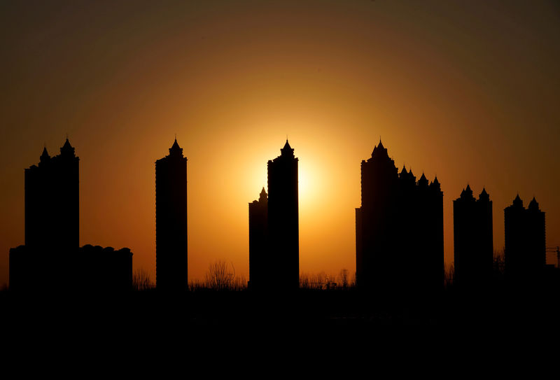 © Reuters. FILE PHOTO - Apartment blocks are pictured during sunset on the outskirts of Tianjin