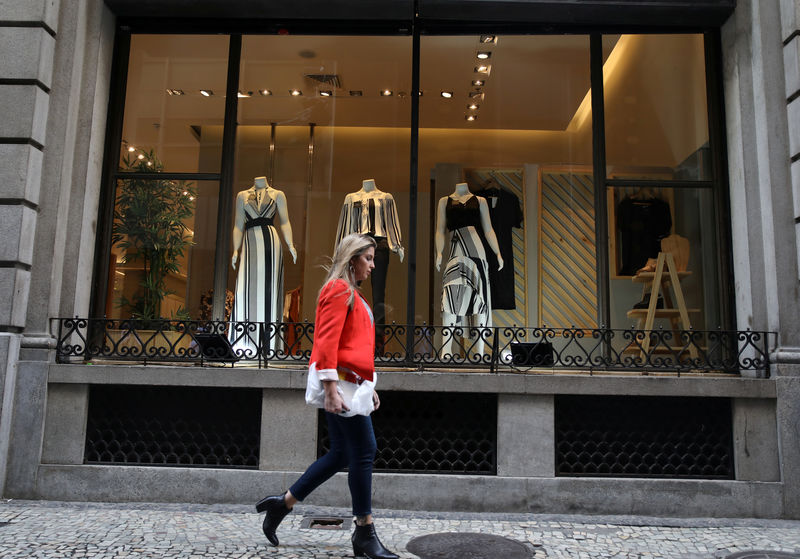 © Reuters. A woman walks past in front of a clothing store in Rio de Janeiro