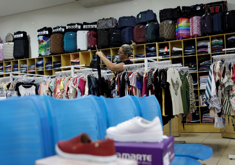 © Reuters. FILE PHOTO: A woman shops at a store in Luis Eduardo Magalhaes