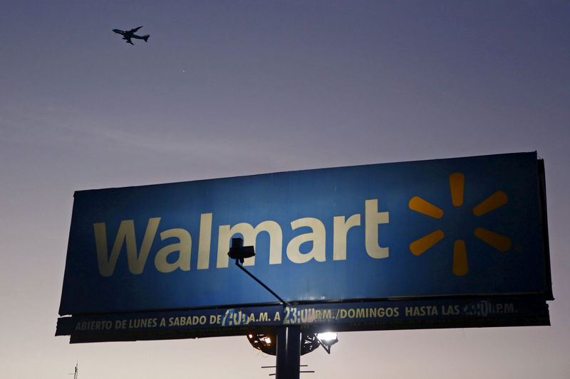 © Reuters. FILE PHOTO: Aircraft flies over a Wal-Mart billboard in Mexico City