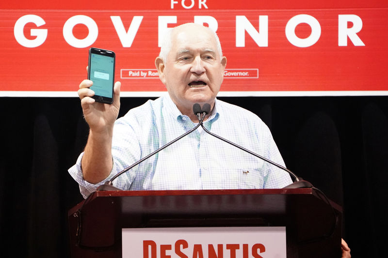 © Reuters. United States Secretary of Agriculture  Sonny Perdue holds up a phone as he attends a rally for candidate for governor Ron DeSantis  in Lakeland,