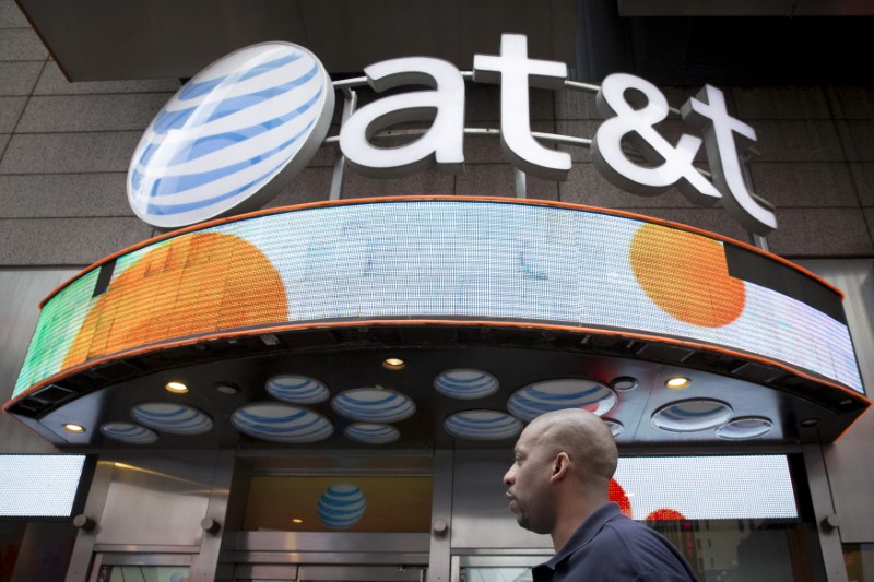 © Reuters. FILE PHOTO: A man walks past the AT&T store in New York's Times Square
