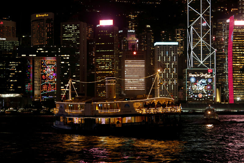 © Reuters. FILE PHOTO - A ferry sails past commercial buildings with Christmas decorations in Hong Kong