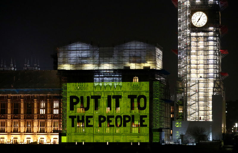 © Reuters. A projection is put on the Houses of Parliament advertising People's Vote March in London