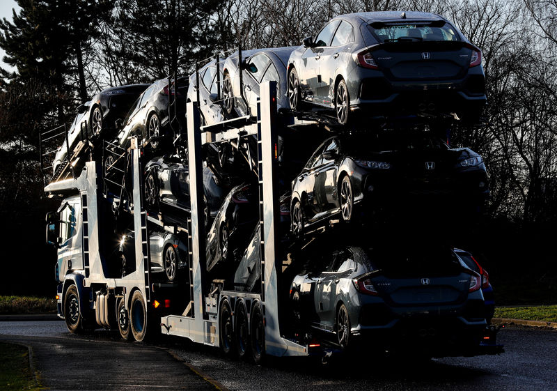 © Reuters. FILE PHOTO: A lorry with car carrier trailer leaves the Honda car plant in Swindon