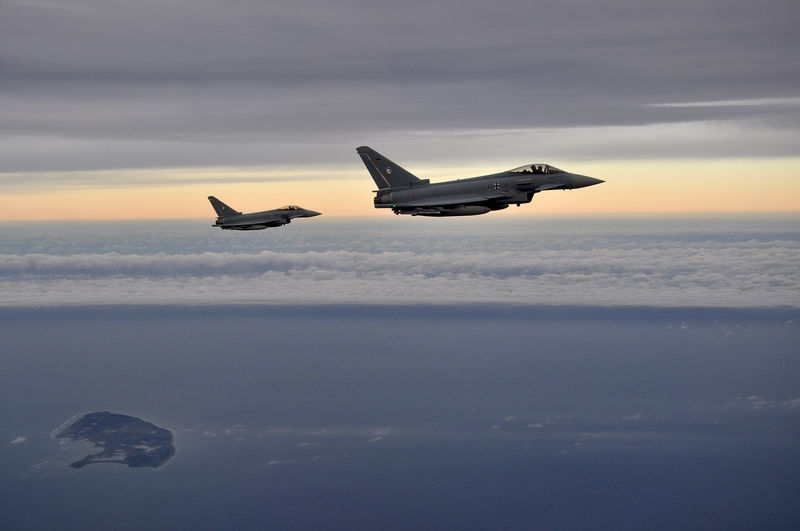 © Reuters. Two German Eurofighter jets simulate the interception of a plane over the Baltic sea