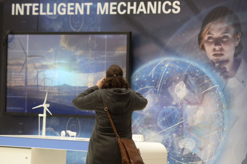 © Reuters. A woman takes a picture of the ZF stand at the Hannover Messe industrial trade fair in Hanover