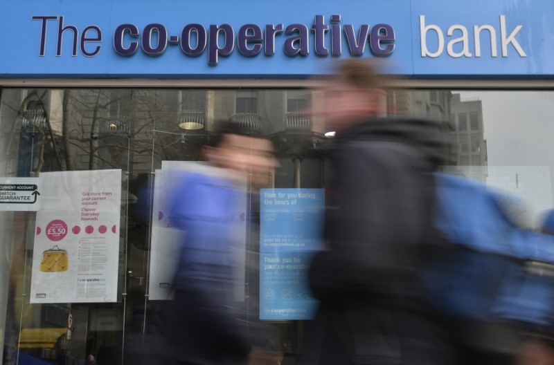© Reuters. FILE PHOTO:  People walk past a branch of The Co-operative Bank in London