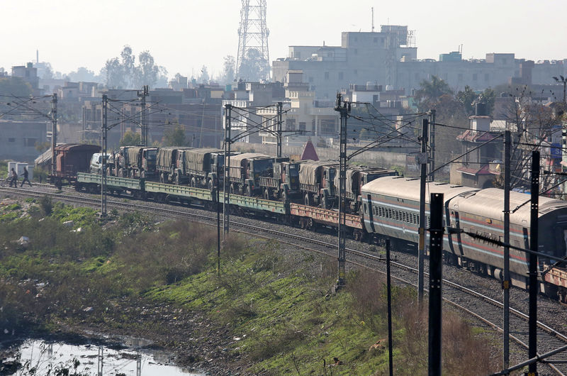 © Reuters. Indian army trucks are transported on a train near a railway station on the outskirts of Jammu