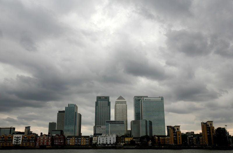 © Reuters. FILE PHOTO: Storm clouds are seen above Canary Wharf financial district in London