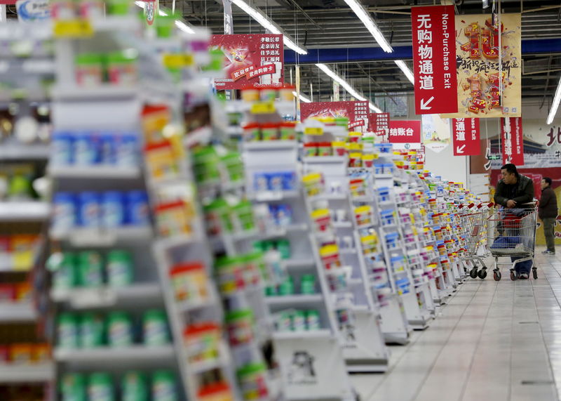 © Reuters. FILE PHOTO: A customer looks around products at Sun Art Retail Group's Auchan hypermarket store in Beijing