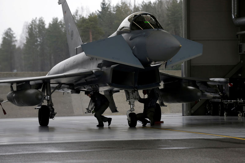 © Reuters. FILE PHOTO: German Air Force technicians inspect Eurofighter Typhoon during the air policing scramble in Amari air base