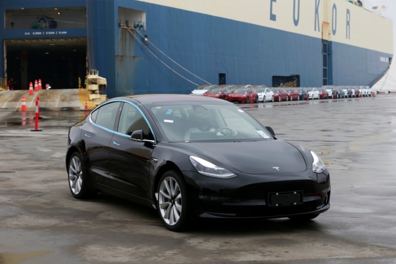 © Reuters. Tesla Model 3 car leaves a cargo vessel at a port in Shanghai