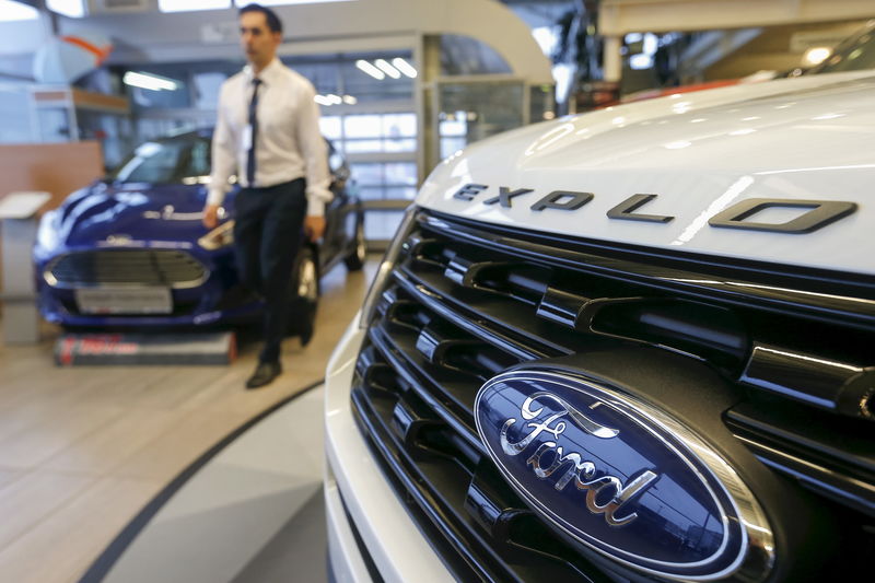 © Reuters. A man walks past Ford cars at a showroom in Moscow, Russia