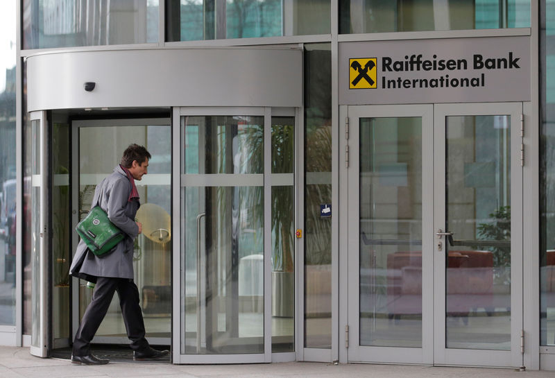 © Reuters. A man enters the headquarters of Raiffeisen Bank International in Vienna