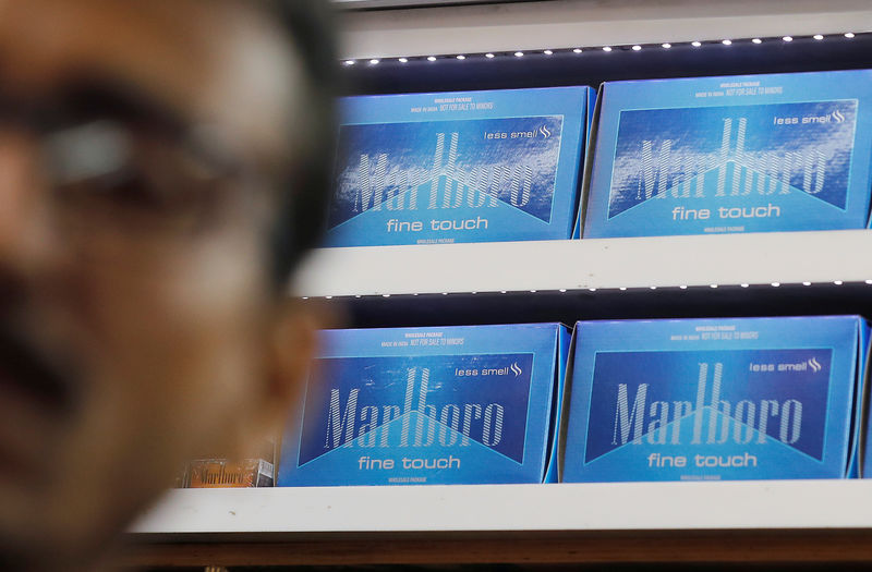 © Reuters. Marlboro cigarette packets are seen inside a stall as a man stands outside in New Delhi