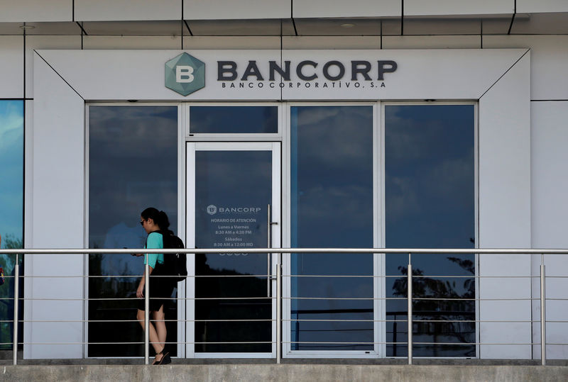 © Reuters. A woman walks past a building of Bancorp (Banco Corporativo S.A) in Managua