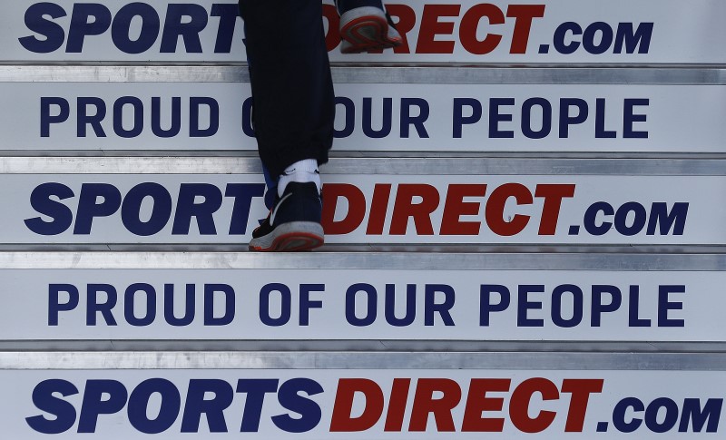 © Reuters. A worker walks up stairs before a Sports Direct general meeting to vote on the re-appointment of chairman Keith Hellawell in Shirebrook