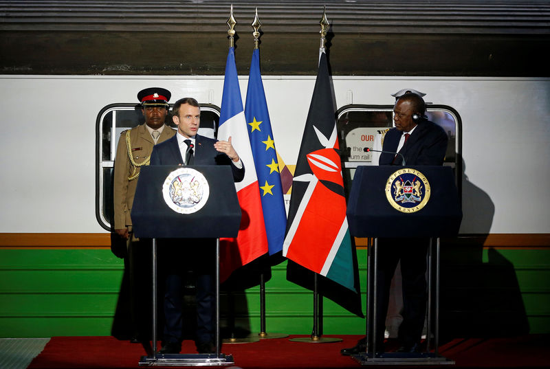 © Reuters. French President Emmanuel Macron flanked by Kenya's President Uhuru Kenyatta address a news conference after touring the Nairobi Central Railway in Nairobi,