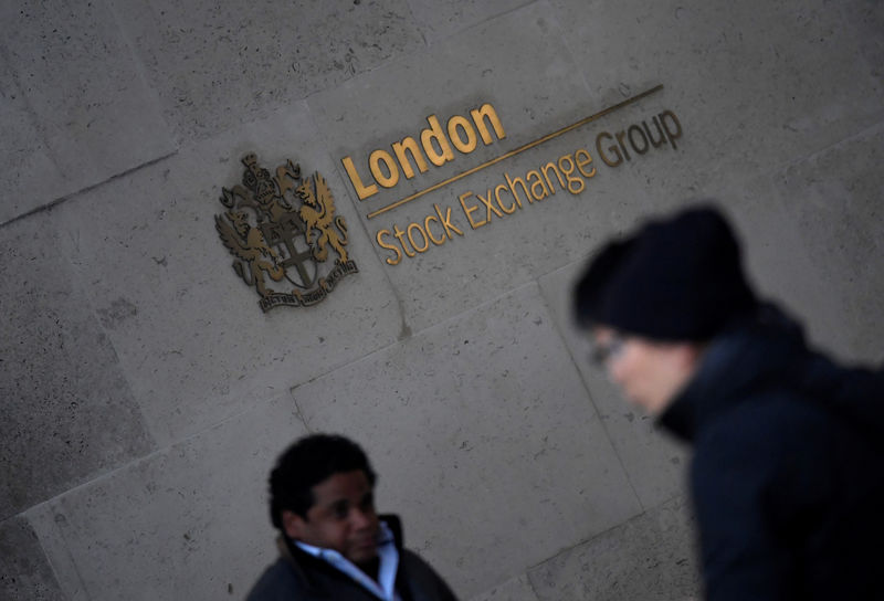 © Reuters. FILE PHOTO: People walk past the London Stock Exchange Group offices in the City of London