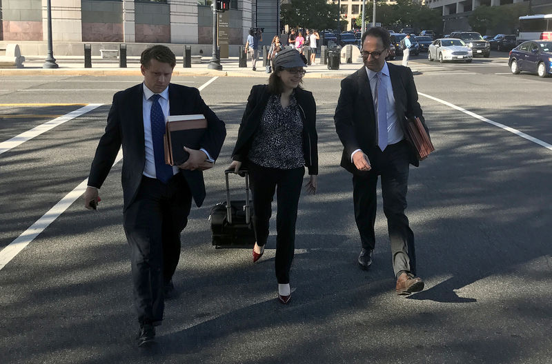 © Reuters. Freeny and Weissmann, members of special counsel Robert Mueller's team of prosecutors leave court in Washington D.C.