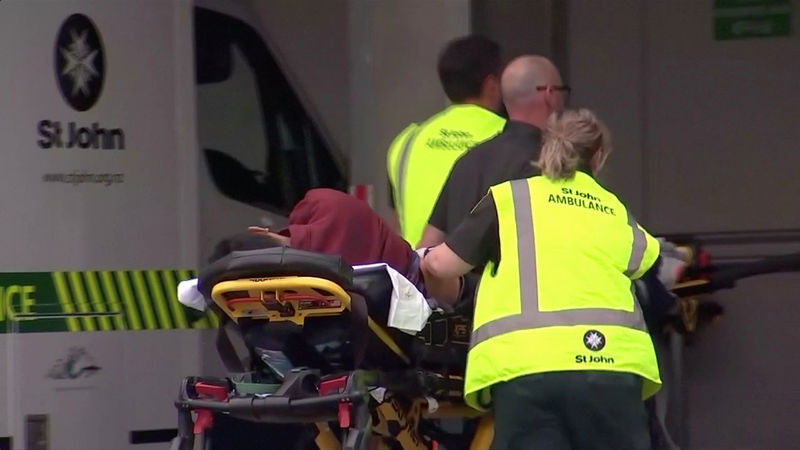 © Reuters. Video grab of emergency services personnel push stretchers carrying a person into a hospital, after reports that several shots had been fired, in central Christchurch