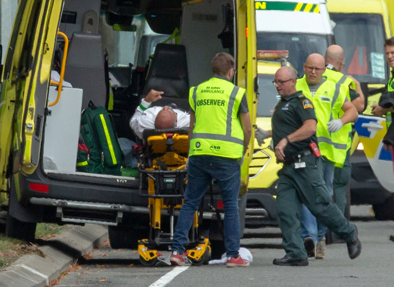 © Reuters. An injured person is loaded into an ambulance following a shooting at the Al Noor mosque in Christchurch